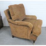 Pair of modern upholstered armchairs, with long cushioned seats, mahogany legs and brass castors,
