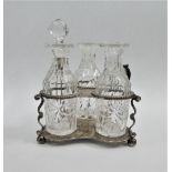 George V silver and glass three bottle cruet stand, London 1922, 11cm high