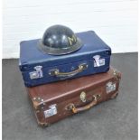 Two vintage suitcases together with a tin helmet, 24 x 62cm, (3)