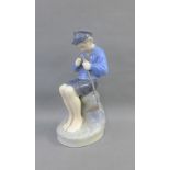 Royal Copenhagen figure of a Boy, modelled seated, with printed back stamps and numbered 905, 19cm