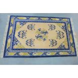 Chinese wool rug with a n ivory field and blue borders, 154 x 260cm