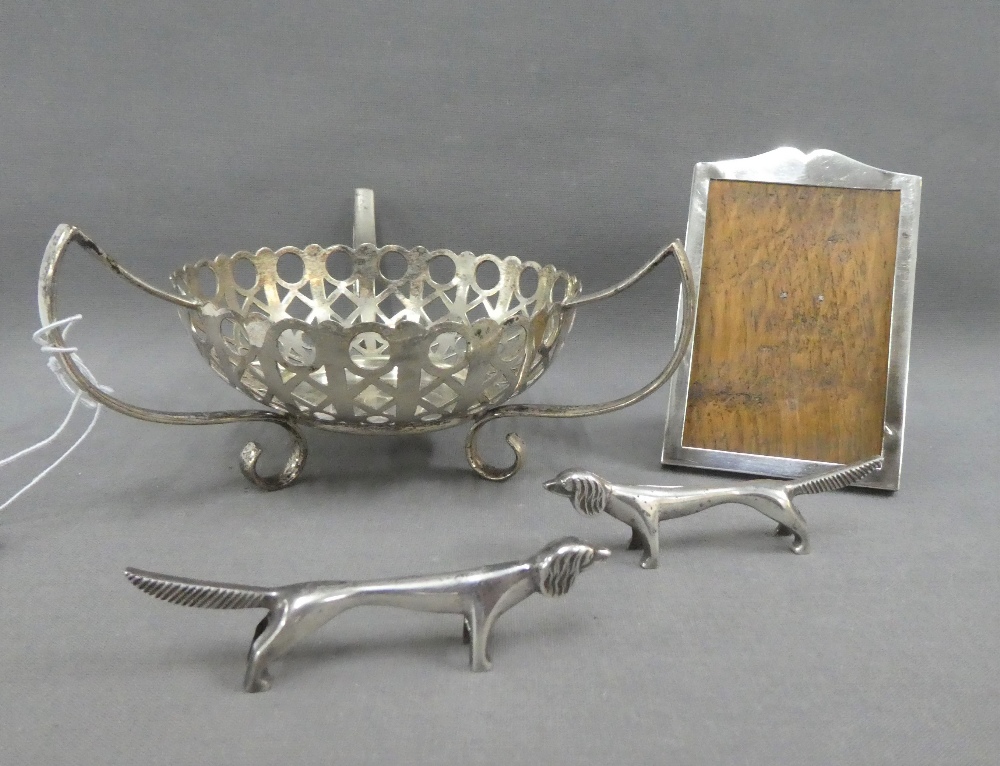 Birmingham silver photograph frame, two white metal dachshund knife rests and an Epns basket (4)