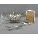 Birmingham silver photograph frame, two white metal dachshund knife rests and an Epns basket (4)