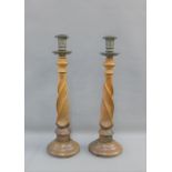 Pair of early 20th century Arts & Crafts barley twist candlesticks with metal sconces, 48cm high, (
