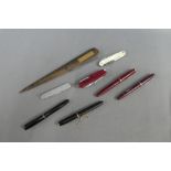 Collection of vintage pens, penknives and a letter opener with a plaque inscribed 'from the