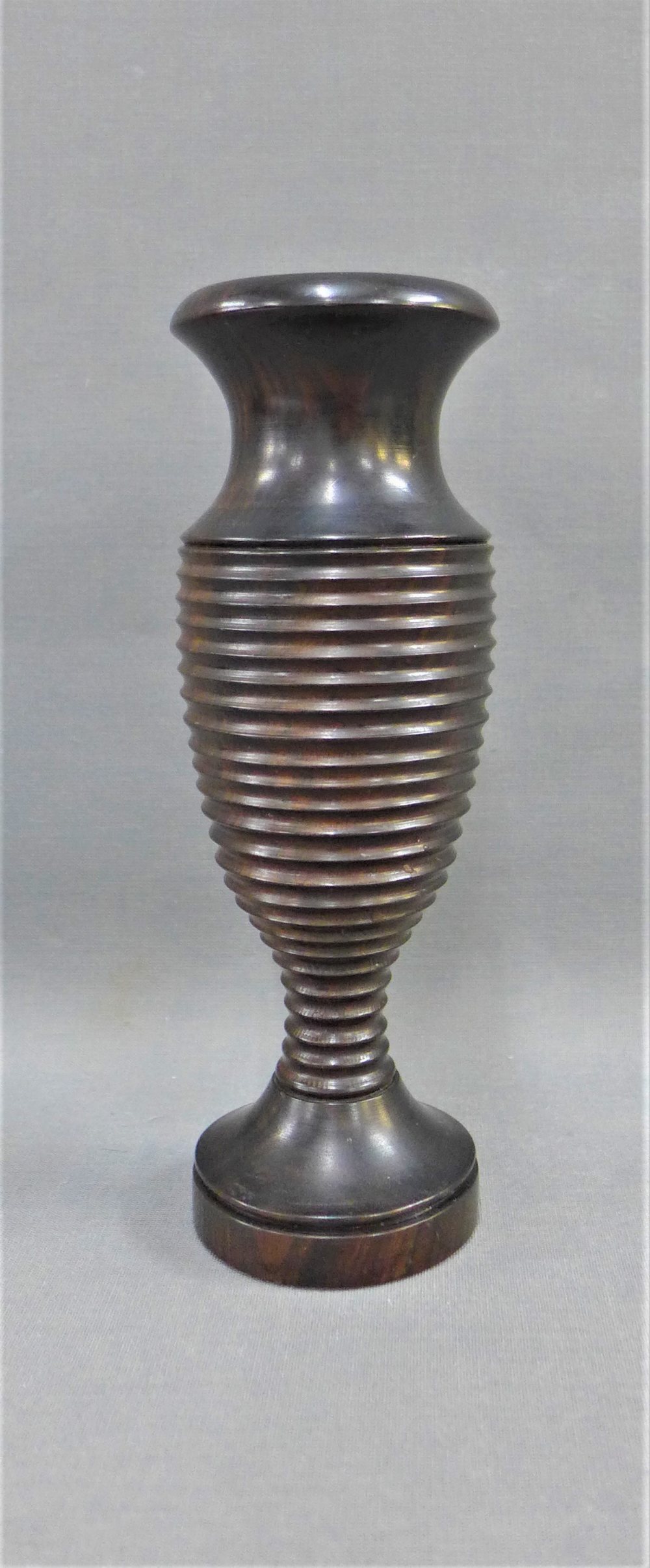 Wooden baluster vase, possibly Lignum Vitae with a ribbed pattern to the body and a circular foot