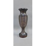 Wooden baluster vase, possibly Lignum Vitae with a ribbed pattern to the body and a circular foot
