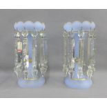 Pair of pale blue opaque glass table lustres with gilt edged rims and clear prisms, 28.5cm high