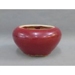 Chinese pottery red glazed bowl with a craquelure interior, 14cm across