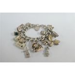 Silver charm bracelet, hung with a quantity of silver and white metal charms, with silver heart
