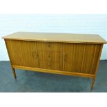 Walnut veneered sideboard with three central drawers flanked by cupboard doors, with brass handles