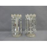 Pair of white opaque glass table lustres with gilt edged rims and clear prisms, 29cm high