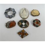 A silver framed cameo brooch and four hardstone brooches, carved horn brooch and a amber brooch (7)