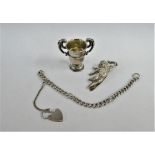 Miniature silver twin handled trophy cup, silver cherub bookmark and a silver bracelet with heart