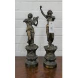Two Spelter female figures on wooden bases, one dancing and one playing the lyre. Tallest is 43cm