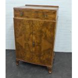Walnut ledgeback cabinet with single long drawer above a pair of cupboard doors, with cabriole legs,