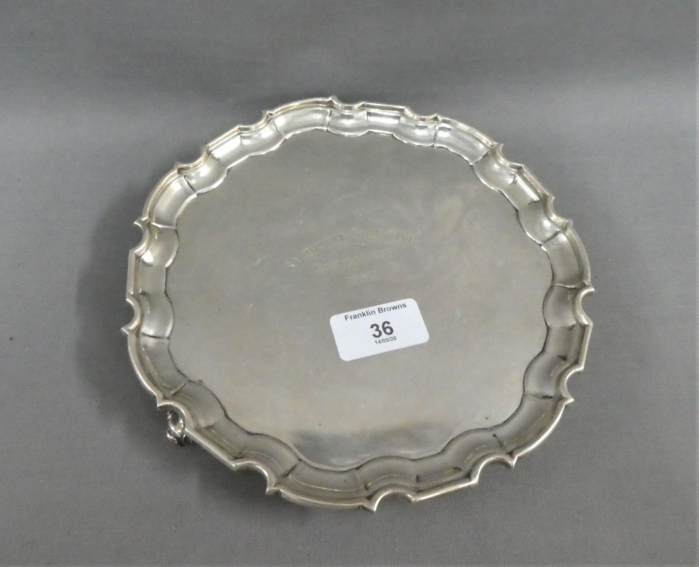 George VI silver waiter, London 1936, with pie crust border and raised on three ball feet, 20cm