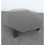 Ebonised coffee table with octagonal glass top, 30 x 101cm
