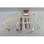 A collection of costume jewellery to include chain necklaces, brooches, pendants, shirt studs,