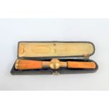 French gold mounted amber cheroot, Sommer of Paris in leather fitted case, (a/f)