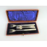 Cased pair of silver and mother of pearl handled pickle forks, Chester 1898 together with two others