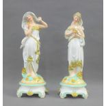 Pair of continental porcelain classical female figures, each modelled standing on a Rococo style