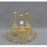 19th century triple gilt glass decanter set together with a scalloped edged circular tray, decanters