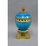 19th century Ormolu and turquoise blue glazed pottery jar with an acorn finial and dolphin tripod