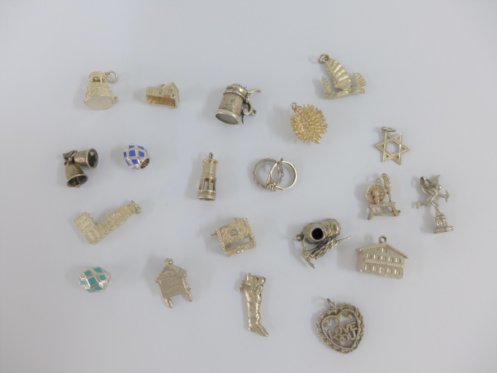 Twenty various silver charms (20)