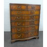 A reproduction mahogany serpentine chest with two short and five graduating long drawers,on