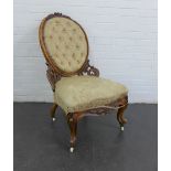 Victorian mahogany framed chair with upholstered button back and seat, on brass caps and ceramic