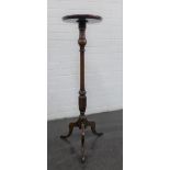 Mahogany torchere with a circular dished top and tripod legs, 108cm high