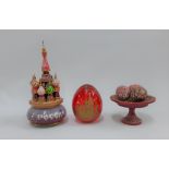 A collection of Russian trinkets to include a red glass egg, St Basils music box, etc