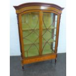 Mahogany display cabinet, the arched top with a dentil frieze and floral painted pattern above a