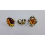 Three silver and amber dress rings (3)