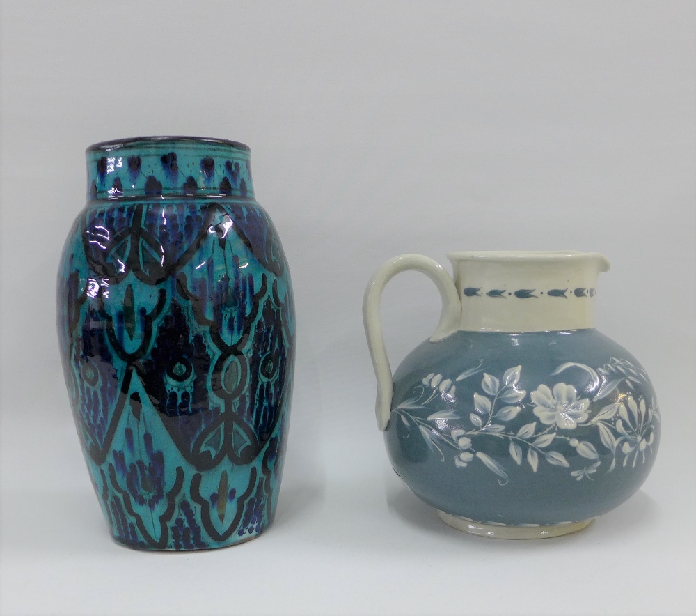Studio pottery grey and white floral patterned jug and a Moroccan style turquoise glazed vase,