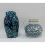 Studio pottery grey and white floral patterned jug and a Moroccan style turquoise glazed vase,