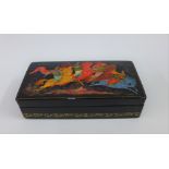 A Russian black lacquered box, signed and dated 1977, 12cm long