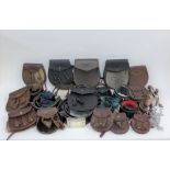 A collection of leather sporrans and kilt belts, etc (a lot)