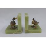 Pair of green hardstone bookends, surmounted with cold painted spelter ducks, (2)