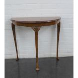 A mahogany demi lune table on cabriole legs, 74 x 72cm