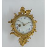 A rococo style gilt metal wall clock, with Roman numerals, 19cm