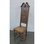 Oak hall chair, the high back with a broken swan neck and carved panel, with solid seat and turned