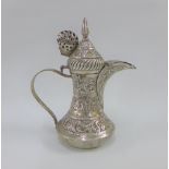 Indian white metal coffee pot of small proportions, with hinged lid and covered spout, base