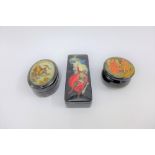 A collection of three Russian black lacquered boxes with painted lids, largest 13cm long (3)