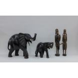 Two African hardwood elephants and a pair of wooden figures, tallest 27cm high (4)