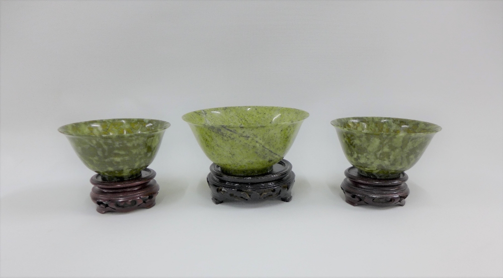 Three green jadeite bowls, largest 13 x 6cm (3)