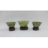 Three green jadeite bowls, largest 13 x 6cm (3)