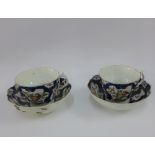 Pair of Dr Wall Worcester cups and saucers, in exotic bird pattern to a blue scale ground, one