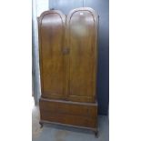 Mahogany wardrobe of small proportions with two arched doors, fitted interior and hanging space,